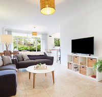 Light and airy garden apartment steps from surf